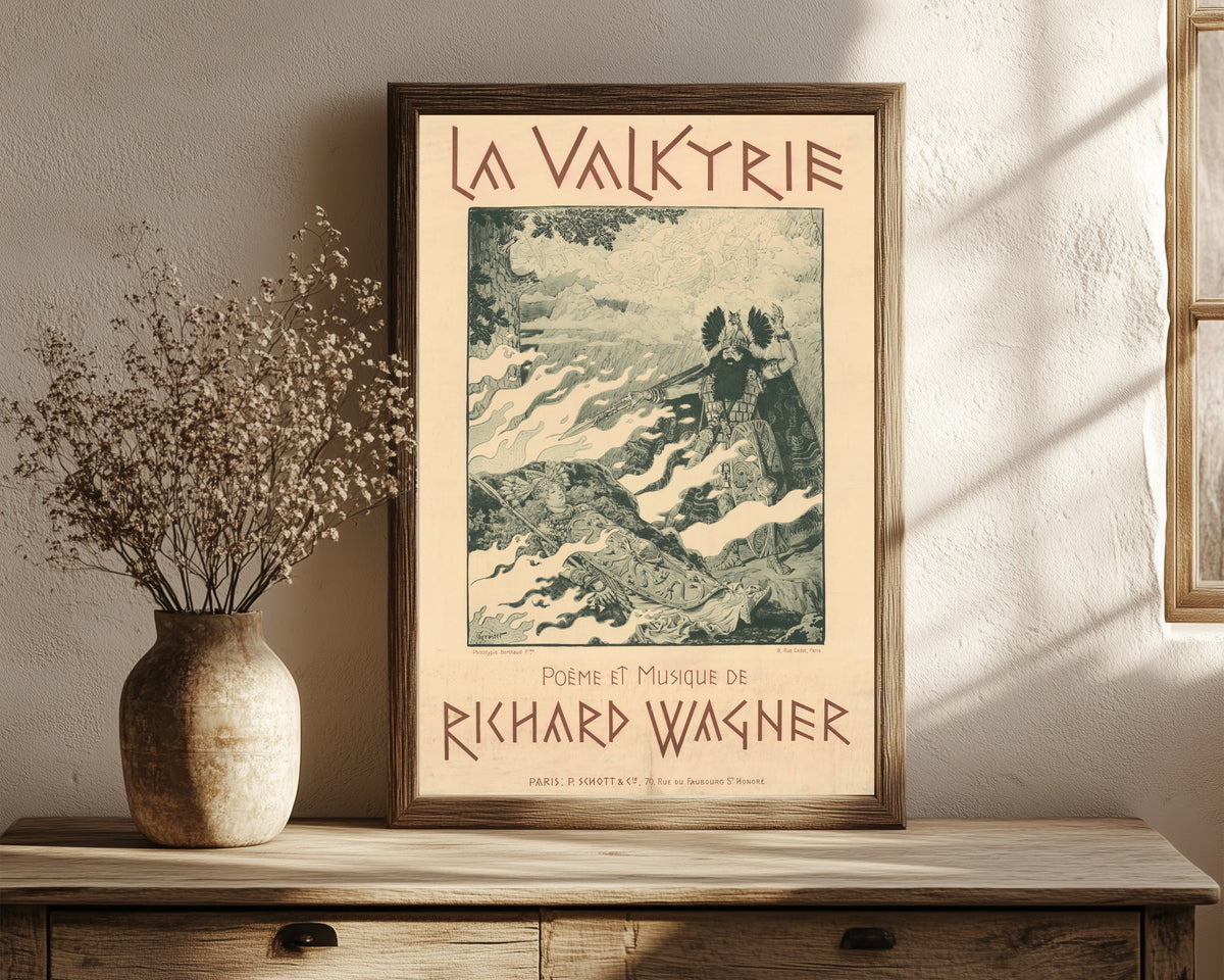 Framed art print of La Valkyrie. Poème et Musique de Richard Wagner by Eugène Grasset, in a dark wood frame leaning on a rustic console beside dried flowers