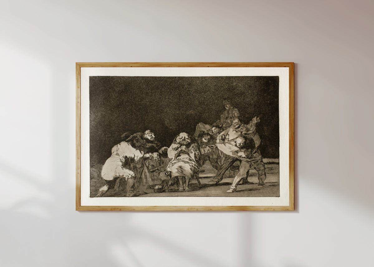 Framed art print of La lealtad (Loyalty), from Los Disparates by Francisco de Goya, in a light wood frame on a sunlit white wall