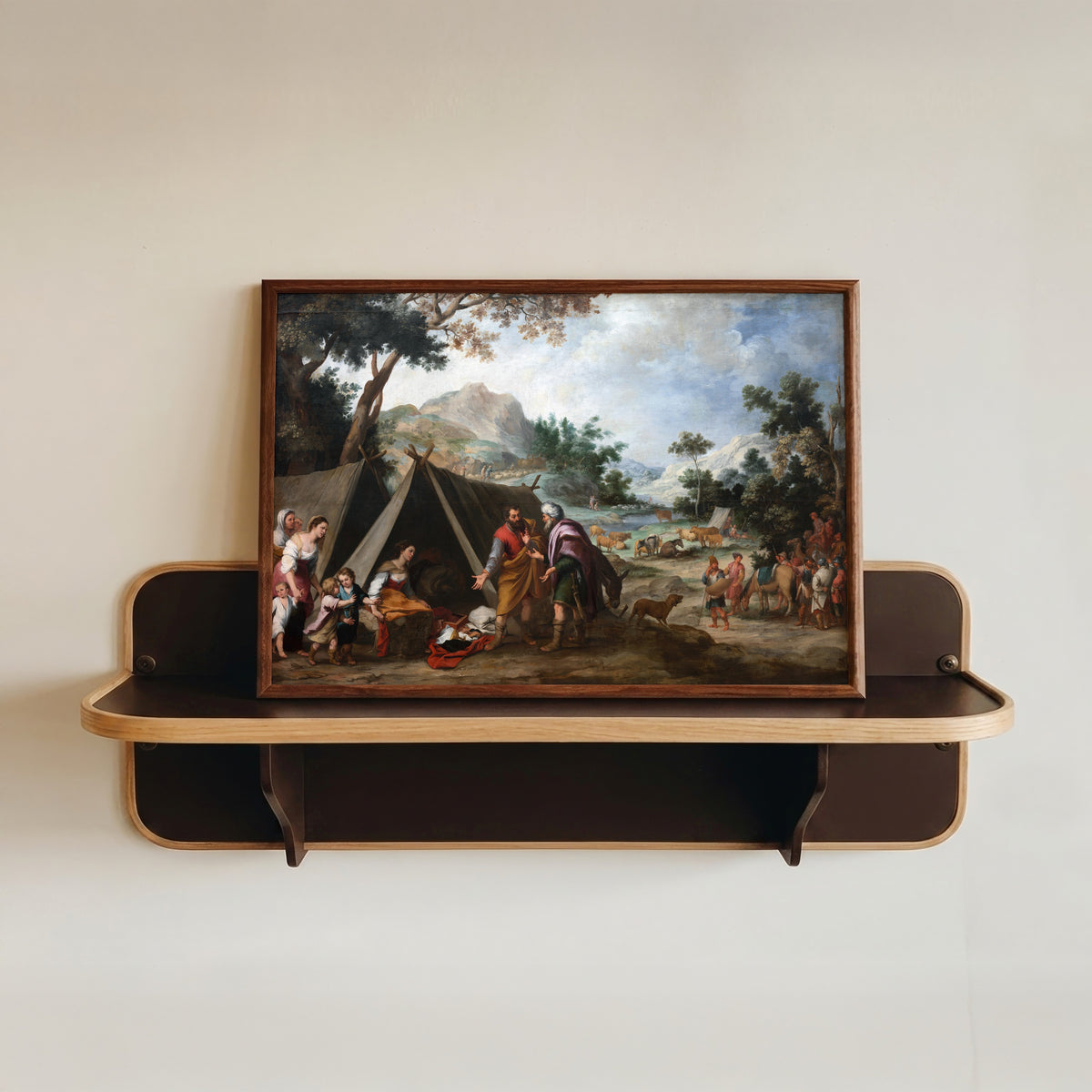 Framed art print of Laban Searching for His Stolen Household Gods by Bartolomé Esteban Murillo, in a dark wood frame resting on a wall shelf