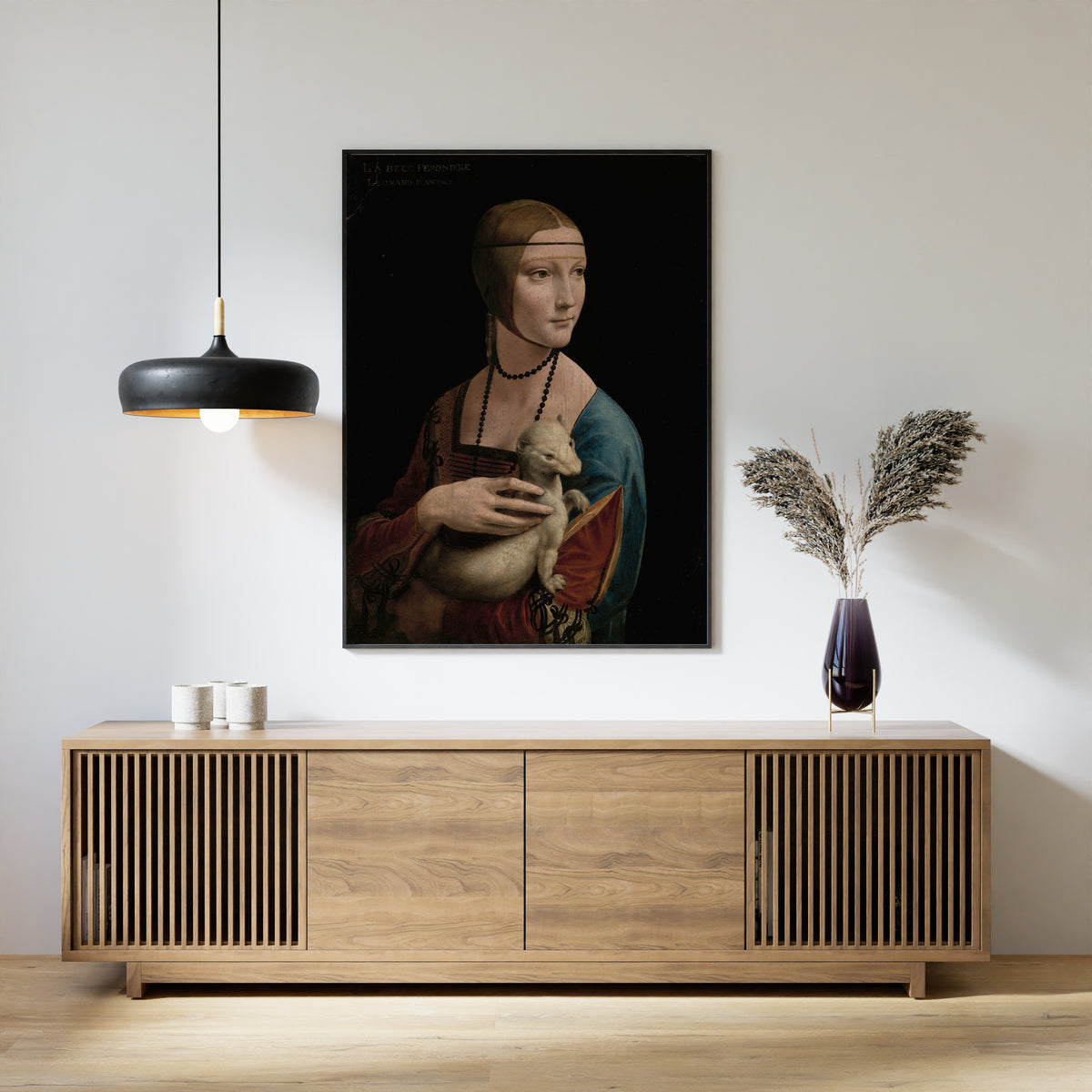 Framed art print of Lady with an Ermine – Portrait of Cecilia Gallerani by Leonardo da Vinci, above a slatted wood sideboard