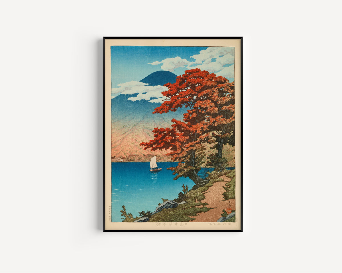 Framed art print of Lake Chuzenji at Nikko by Kawase Hasui, in a slim black frame on a plain white wall