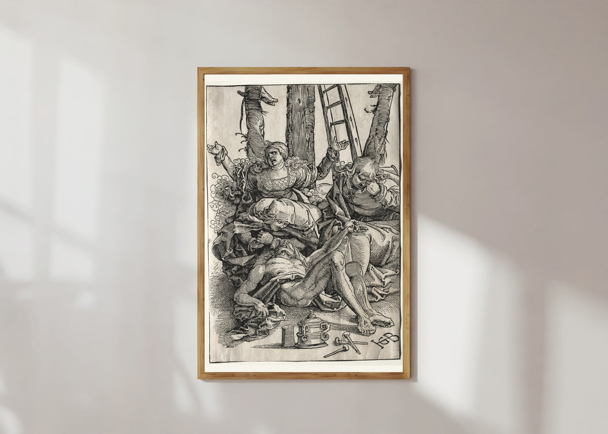 Framed art print of Lamentation by Hans Baldung Grien, in a light wood frame on a sunlit white wall