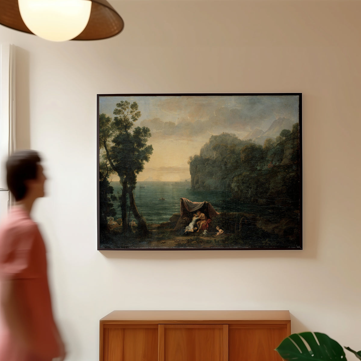 Framed art print of Landscape with Acis and Galatea by Claude Lorrain, in a slim black frame on a warm wall in a sunlit room