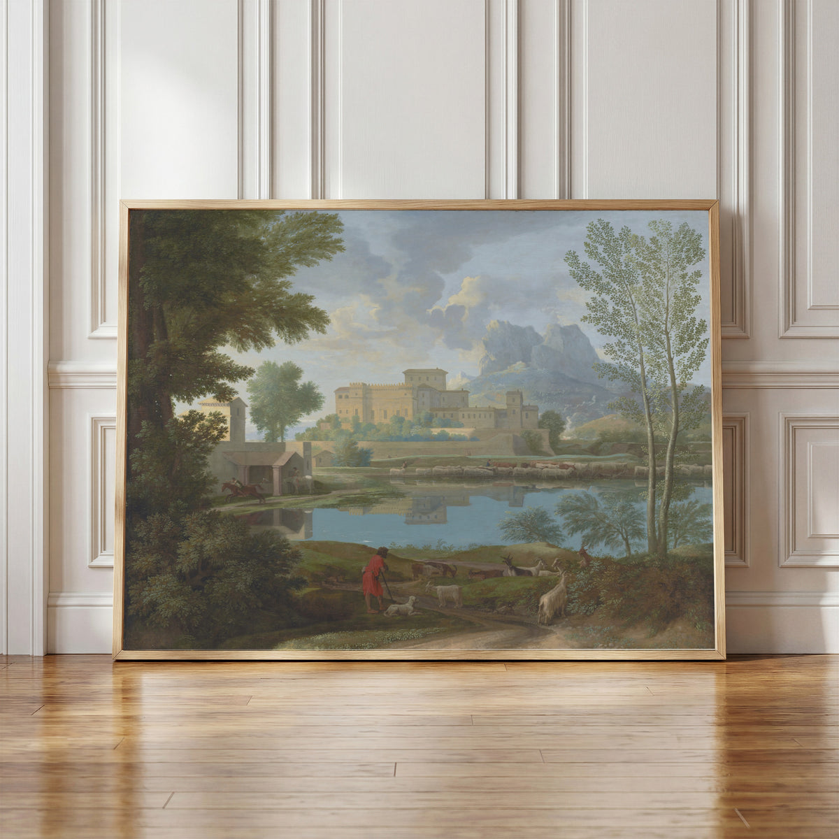 Framed art print of Landscape with a Calm by Nicolas Poussin, in a light wood frame leaning against a panelled white wall
