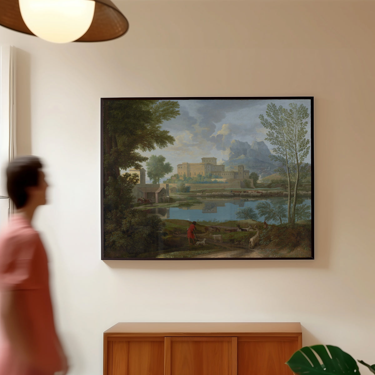 Framed art print of Landscape with a Calm by Nicolas Poussin, in a slim black frame on a warm wall in a sunlit room
