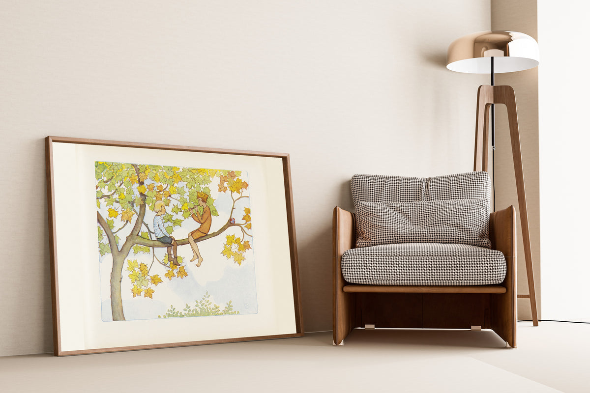 Framed art print of Lasse and September in the Maple Tree by Elsa Beskow, leaning against a wall beside an armchair and a floor lamp