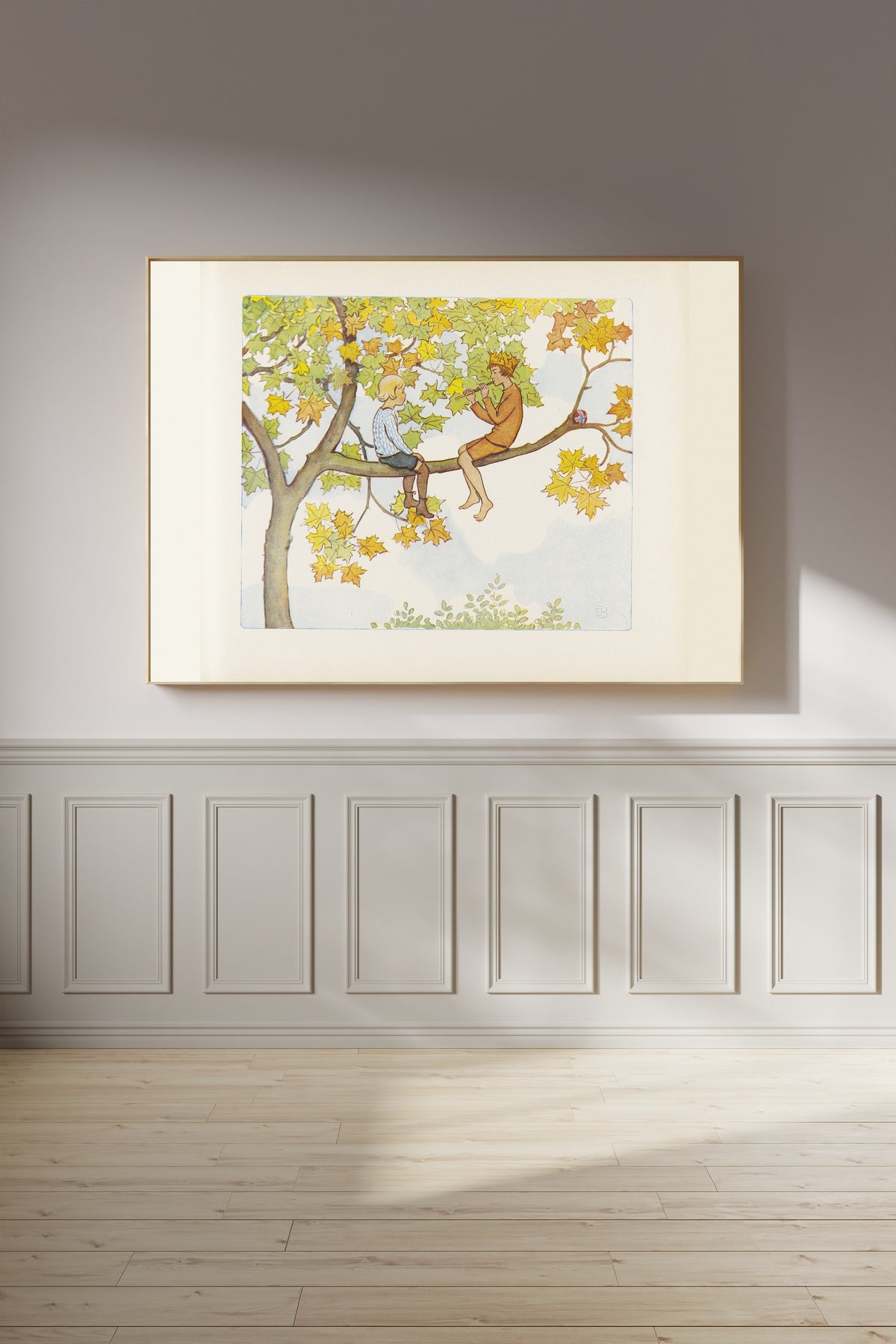 Framed art print of Lasse and September in the Maple Tree by Elsa Beskow, on a panelled wall in afternoon light