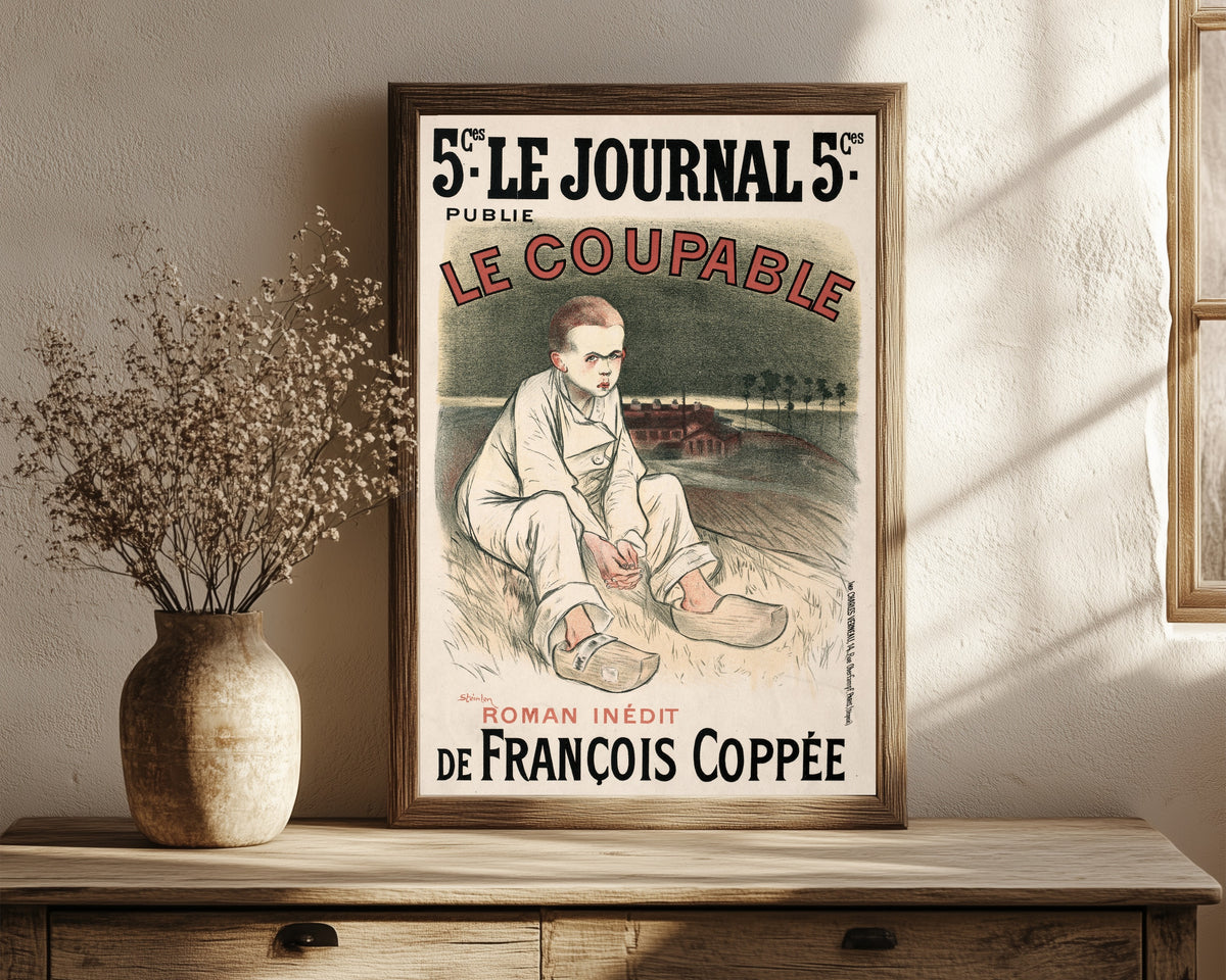 Framed art print of Le Journal: Le Coupable by Théophile Steinlen, in a dark wood frame leaning on a rustic console beside dried flowers