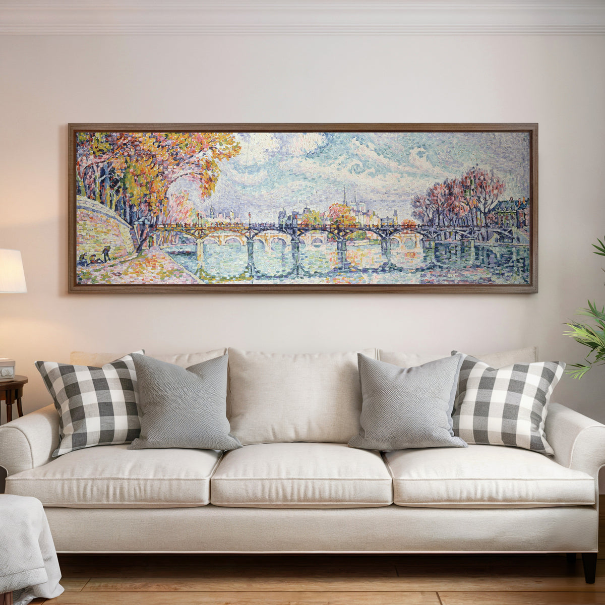 Framed art print of Le Pont des Arts (1928) by Paul Signac, above a cream sofa