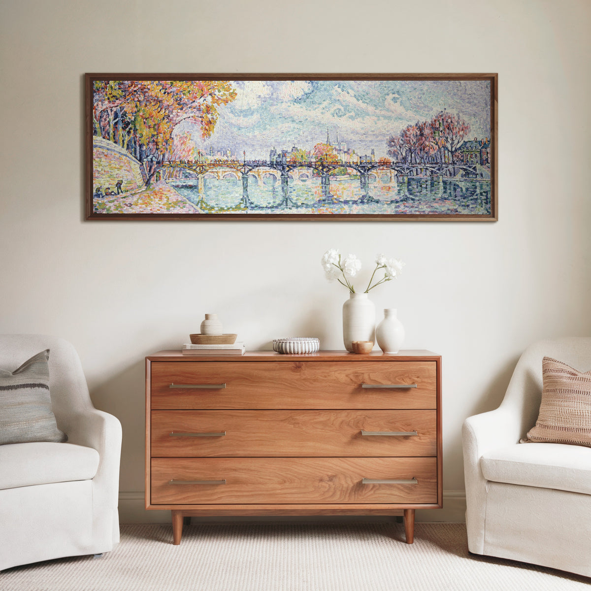 Framed art print of Le Pont des Arts (1928) by Paul Signac, above a wooden chest of drawers