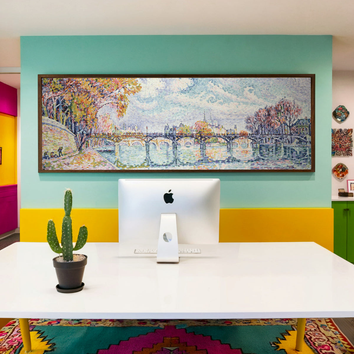 Framed art print of Le Pont des Arts (1928) by Paul Signac, above a desk