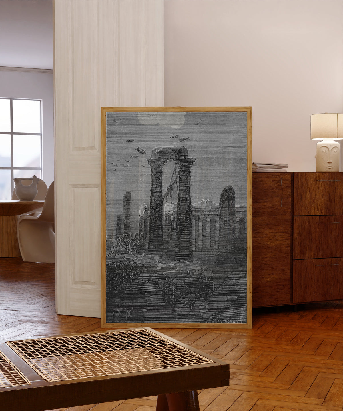 Framed art print of Le temple d'Hercule (The Temple of Hercules) by Alphonse de Neuville, in a light wood frame leaning in a warm room with a parquet floor