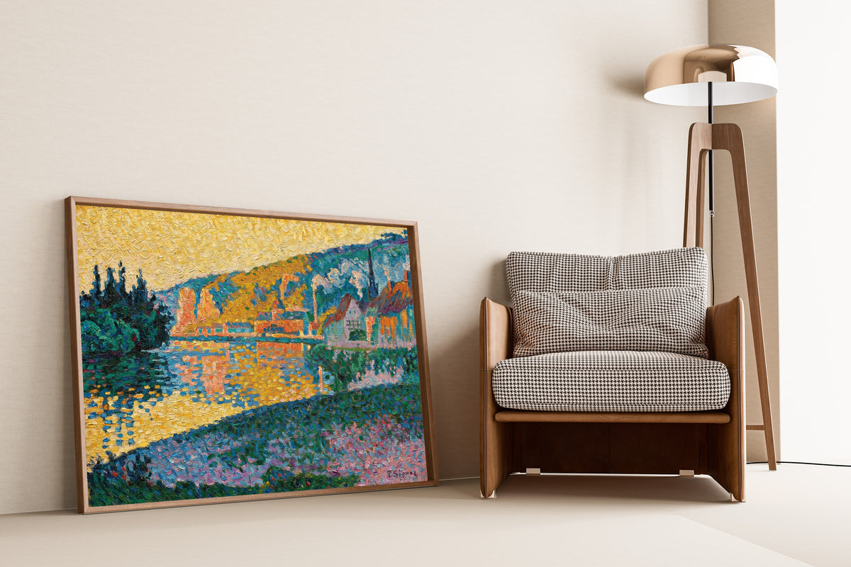Framed art print of Les Andelys, Sunset by Paul Signac, leaning against a wall beside an armchair and a floor lamp