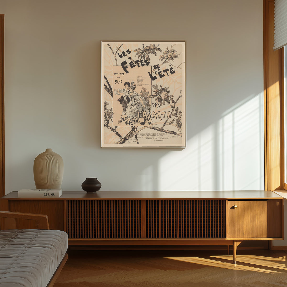Framed art print of Les Fêtes de l’été, passepied pour piano par Th. de… by Théophile Steinlen, in a thin light frame on a sunlit wall above a wooden sideboard