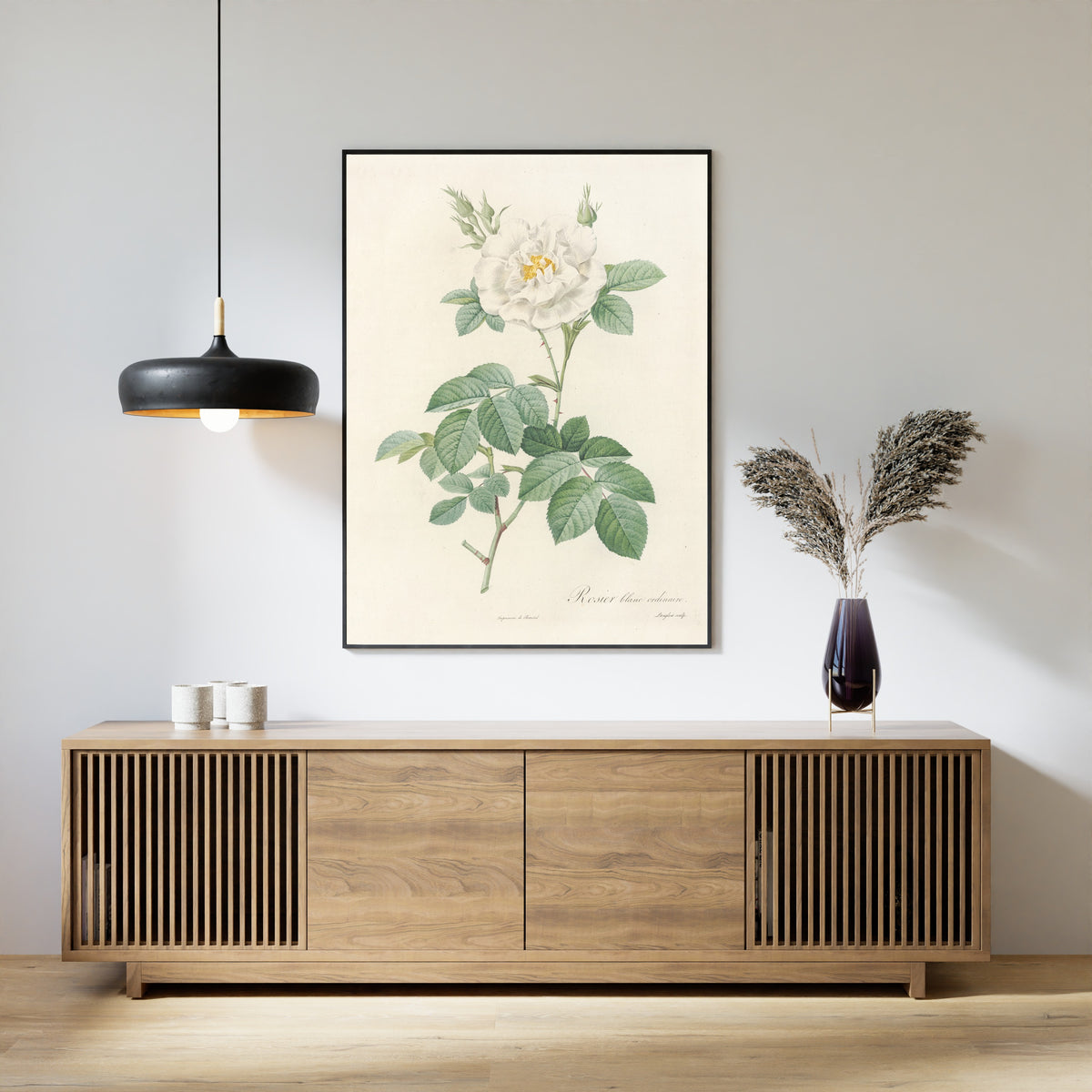 Framed art print of Les Roses: Rosa Alba Flore Pleno by Pierre-Joseph Redouté, above a slatted wood sideboard
