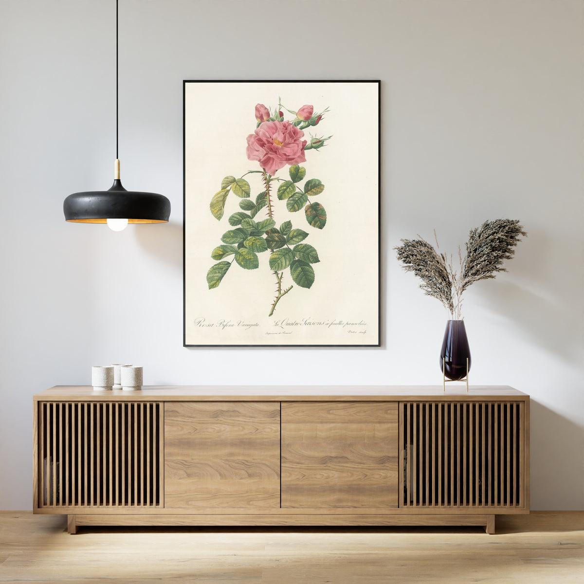 Framed art print of Les Roses: Rosa Bifera Variegata by Pierre-Joseph Redouté, above a slatted wood sideboard