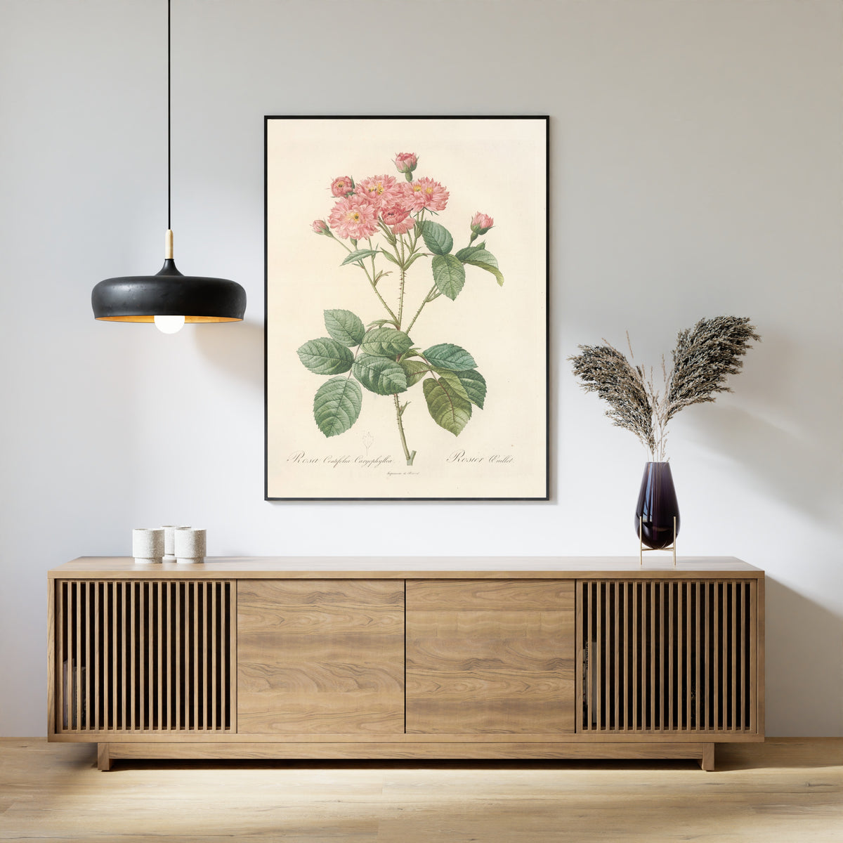 Framed art print of Les Roses: Rosa Centifolia Caryophyllea by Pierre-Joseph Redouté, above a slatted wood sideboard