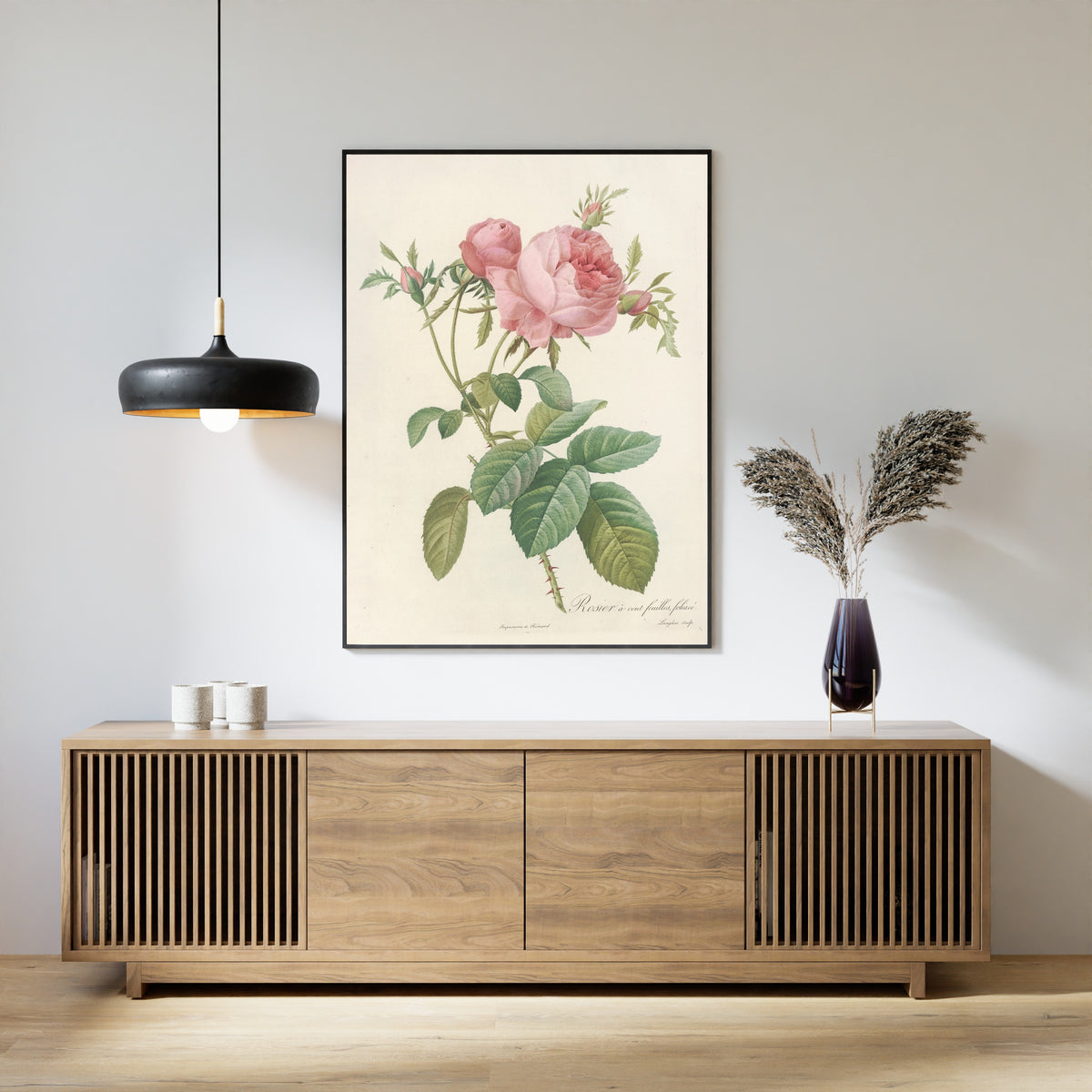 Framed art print of Les Roses: Rosa Centifolia Foliacea by Pierre-Joseph Redouté, above a slatted wood sideboard
