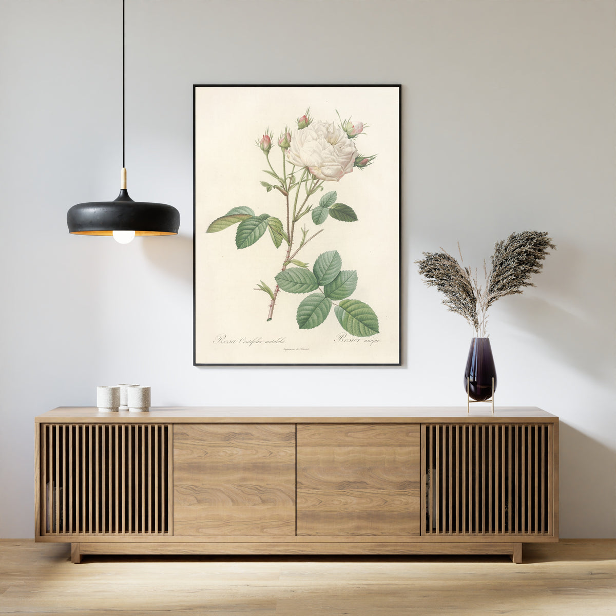 Framed art print of Les Roses: Rosa Centifolia Mutabilis by Pierre-Joseph Redouté, above a slatted wood sideboard