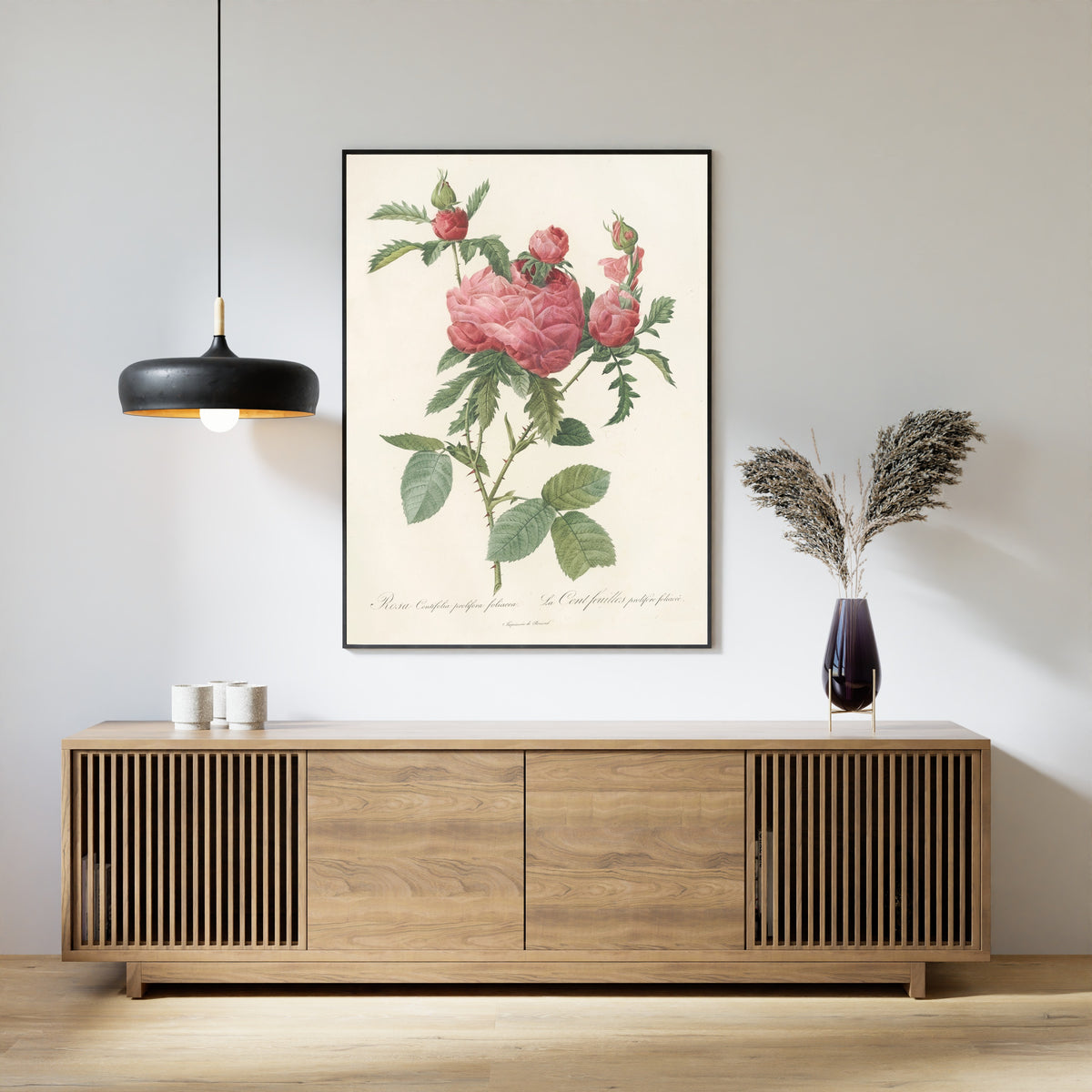 Framed art print of Les Roses: Rosa Centifolia Prolifera Foliacea by Pierre-Joseph Redouté, above a slatted wood sideboard