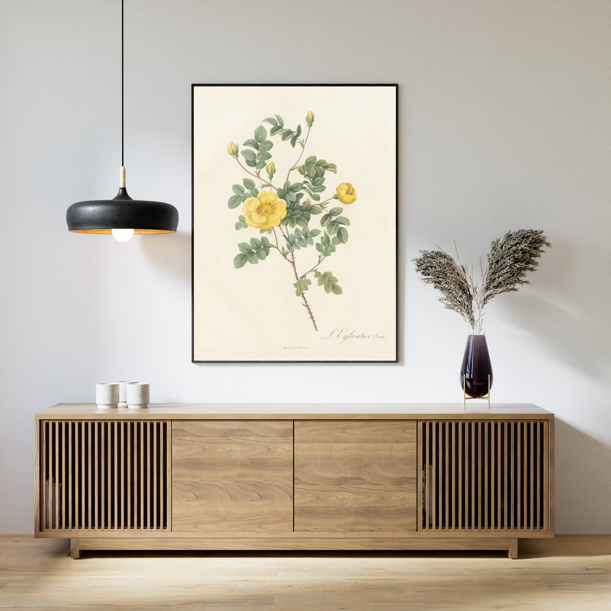 Framed art print of Les Roses: Rosa Eglanteria Luteola by Pierre-Joseph Redouté, above a slatted wood sideboard