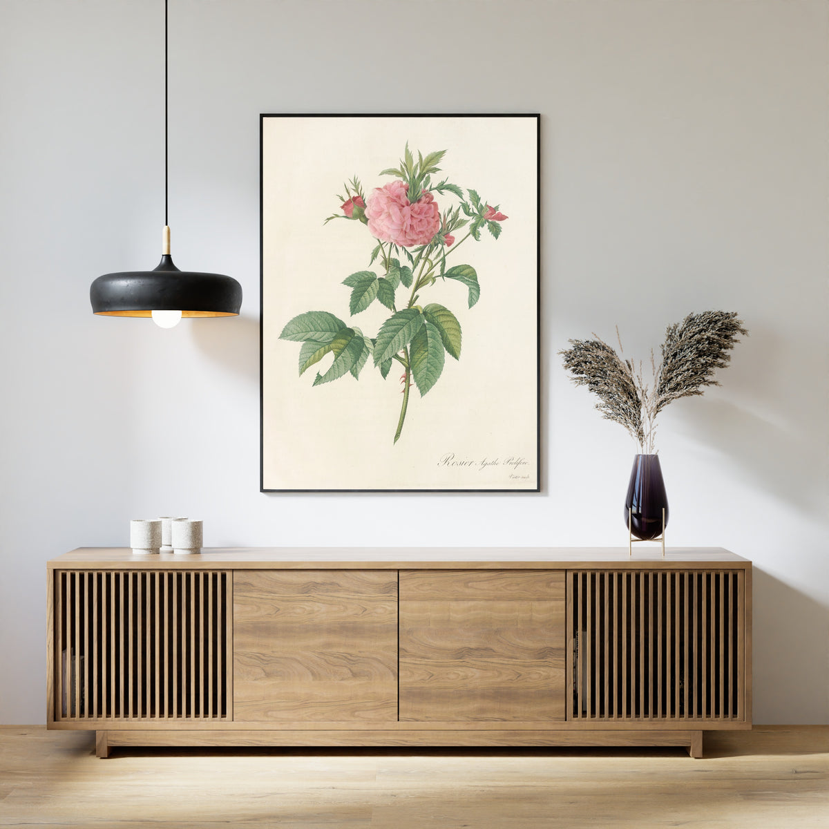 Framed art print of Les Roses: Rosa Gallica Agatha (Var. Prolifera) by Pierre-Joseph Redouté, above a slatted wood sideboard
