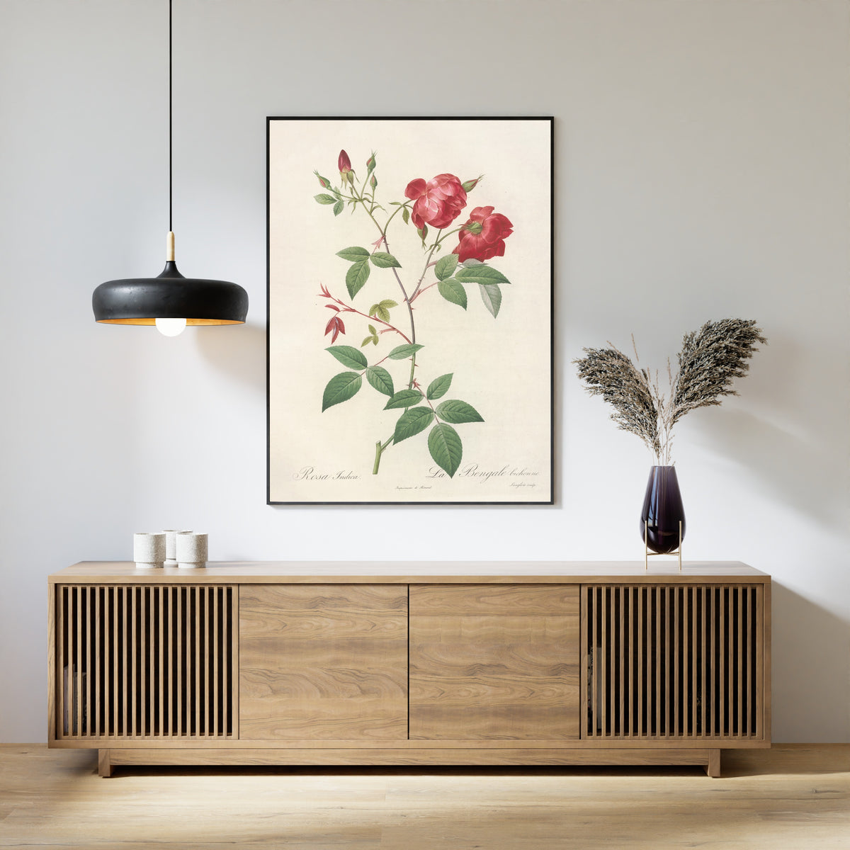 Framed art print of Les Roses: Rosa Indica (La Bengale Bichonne) by Pierre-Joseph Redouté, above a slatted wood sideboard