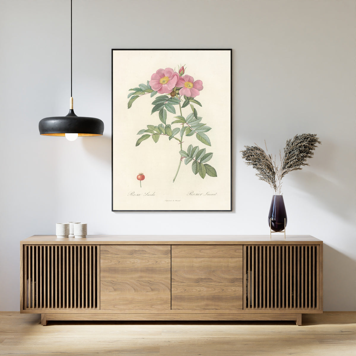 Framed art print of Les Roses: Rosa Lucida by Pierre-Joseph Redouté, above a slatted wood sideboard