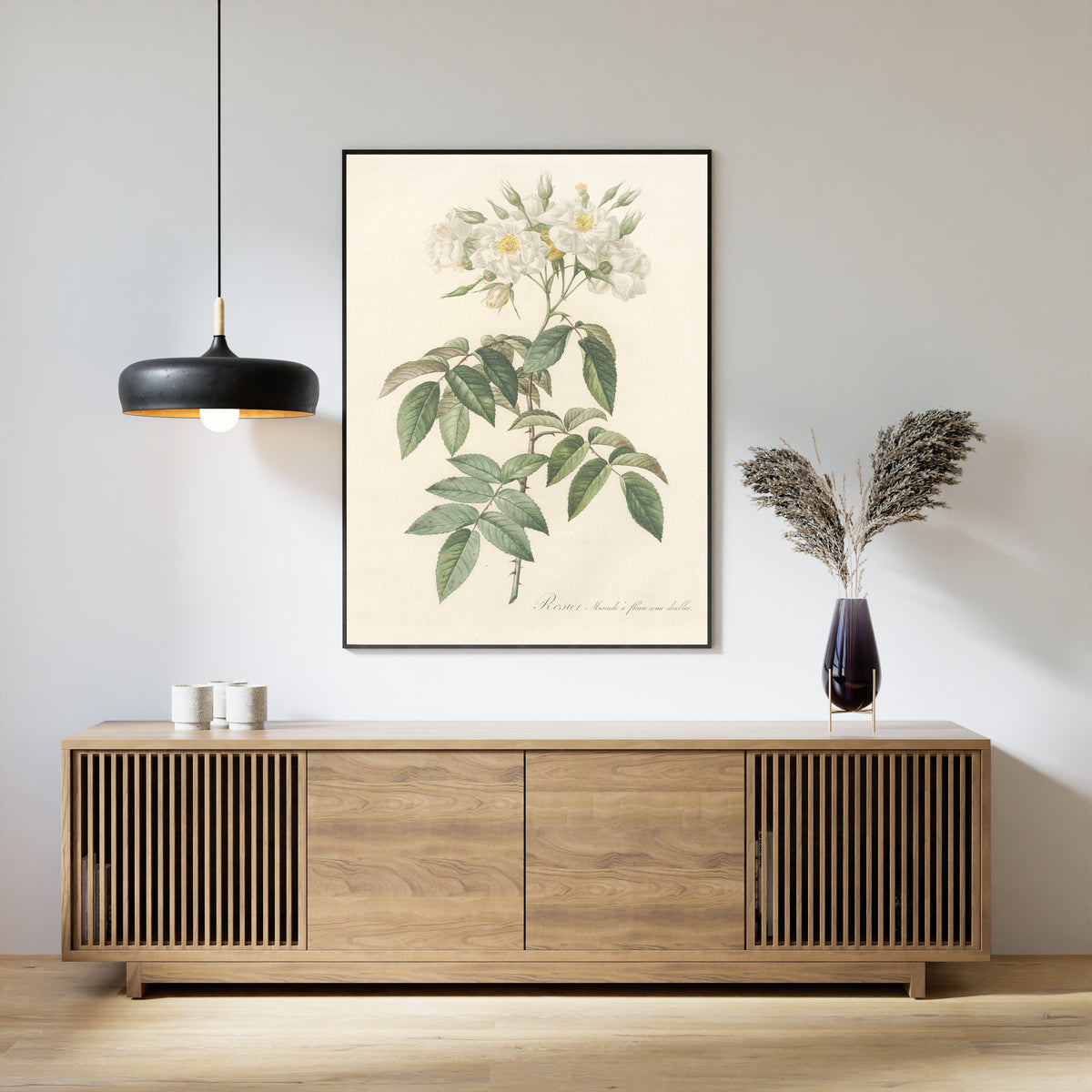 Framed art print of Les Roses: Rosa Moschata Flore Semi-Pleno by Pierre-Joseph Redouté, above a slatted wood sideboard