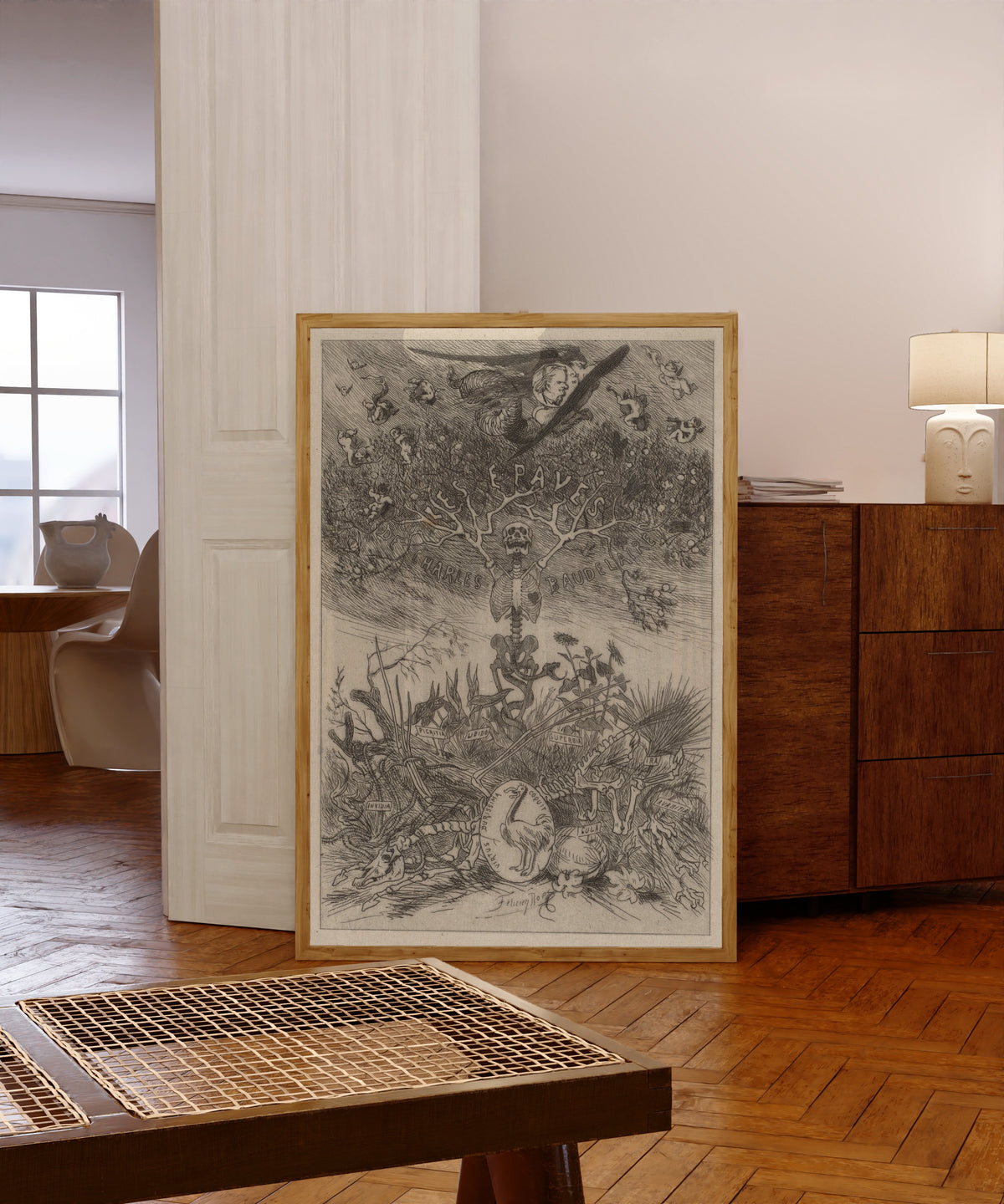 Framed art print of Les Épaves: Frontispiece by Félicien Rops, in a light wood frame leaning in a warm room with a parquet floor