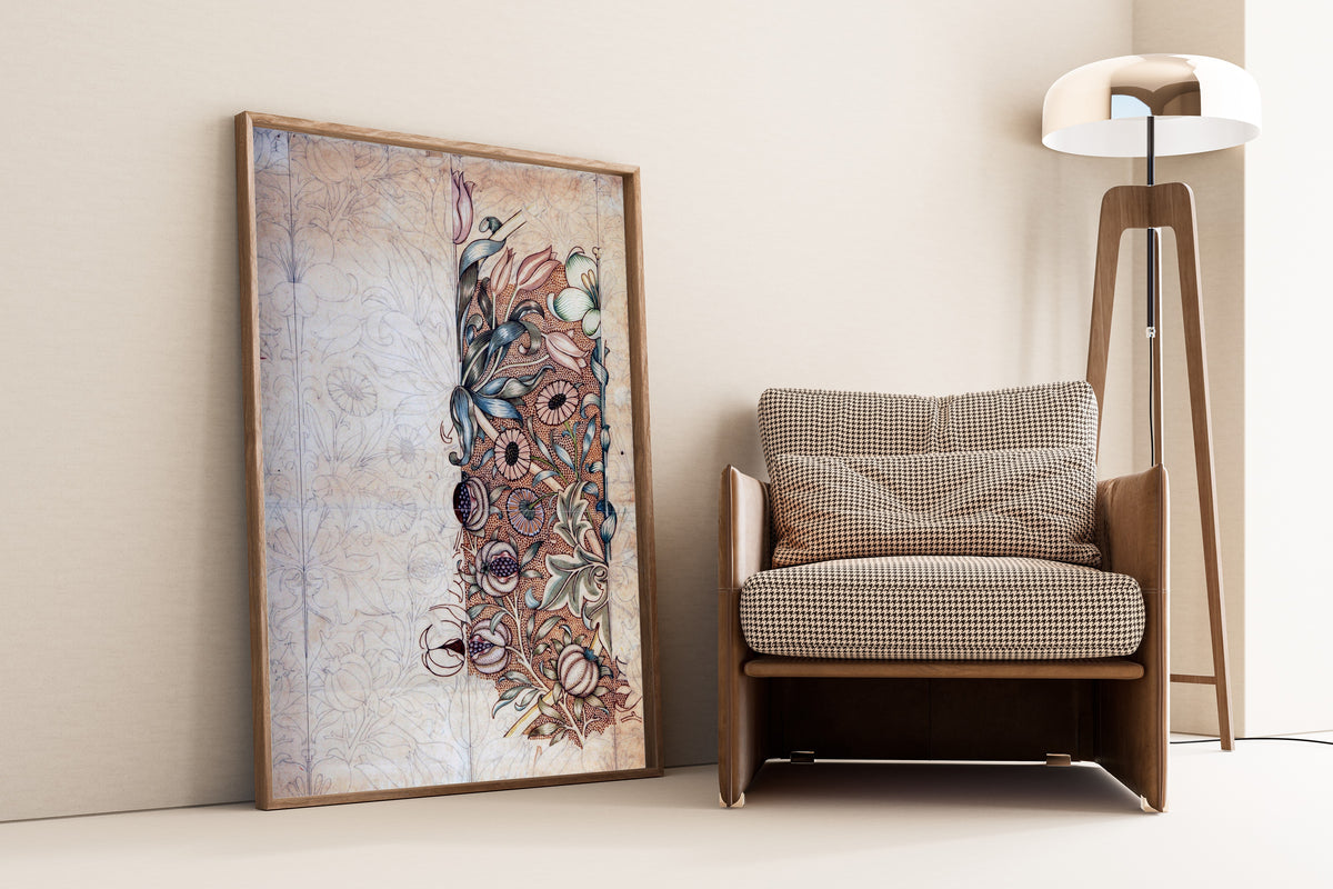 Framed art print of Lily and Pomegranate (Design Drawing) by William Morris, leaning against a wall beside an armchair and a floor lamp