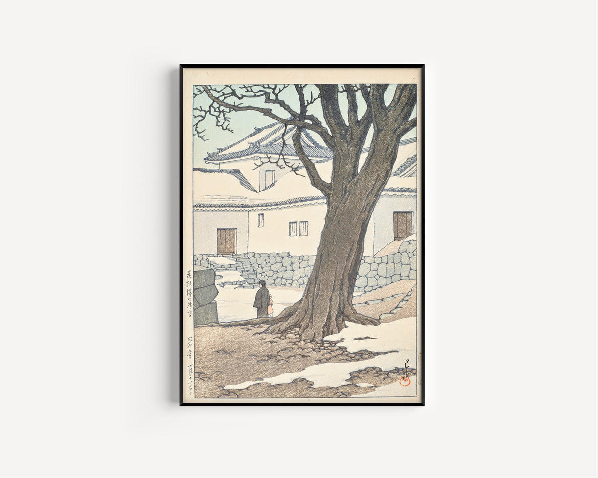 Framed art print of Lingering Snow at Hikone Castle by Kawase Hasui, in a slim black frame on a plain white wall