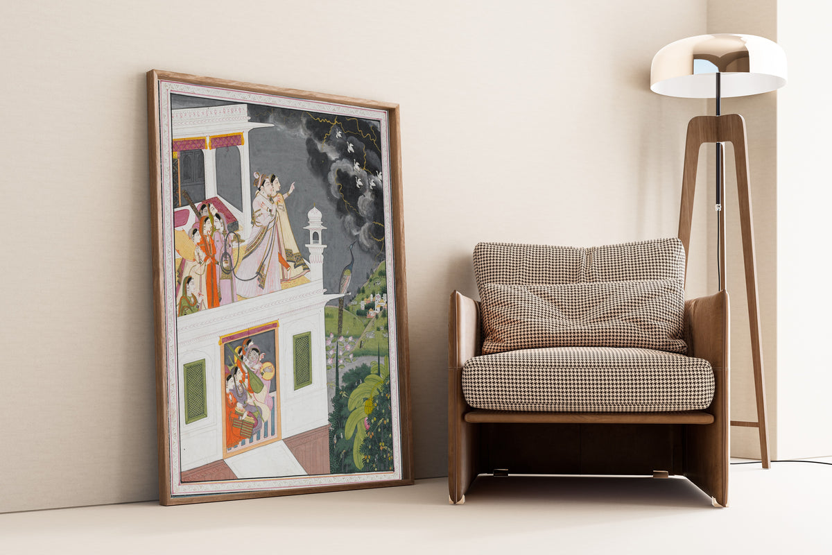 Framed art print of Lovers Watching an Approaching Thunderstorm by Kangra school, leaning against a wall beside an armchair and a floor lamp