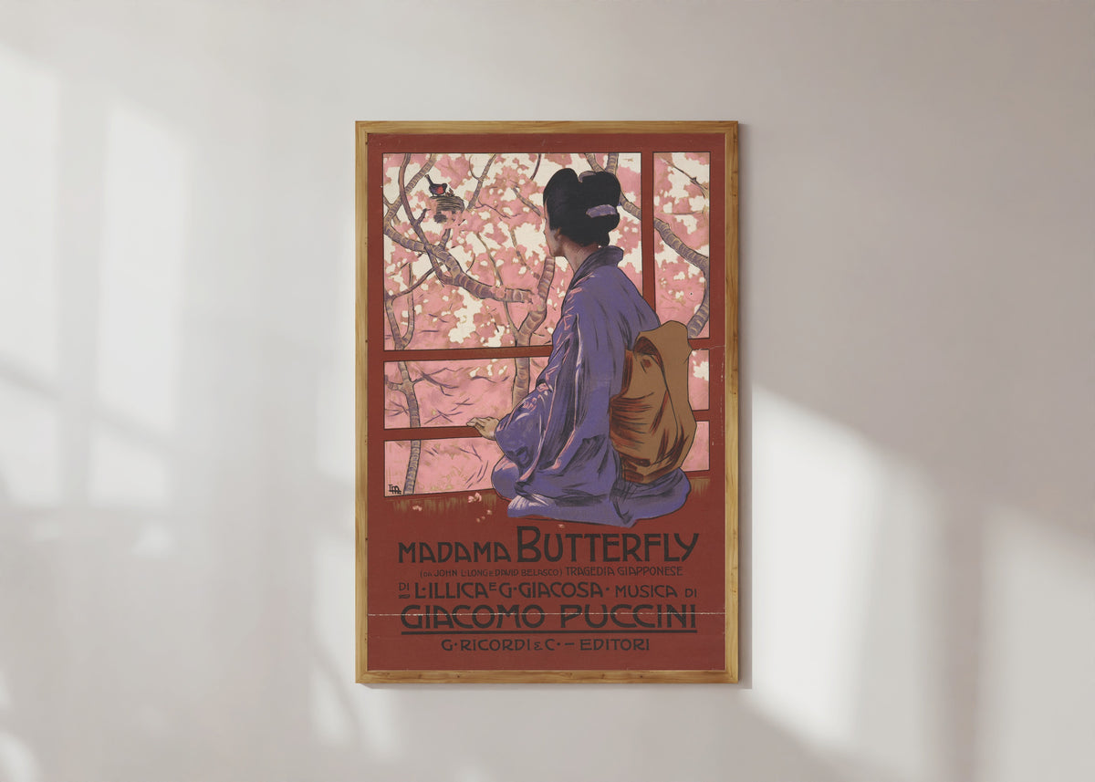 Framed art print of Madama Butterfly: Tragedia giapponese by Leopoldo Metlicovitz, in a light wood frame on a sunlit white wall