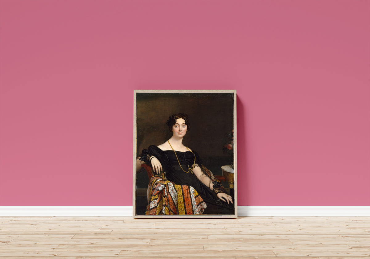 Framed art print of Madame Jacques-Louis Leblanc… by Jean-Auguste-Dominique Ingres, in a light wood frame leaning on a pink wall above a wooden floor