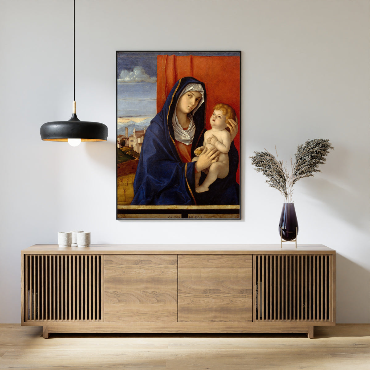 Framed art print of Madonna and Child by Giovanni Bellini, above a slatted wood sideboard