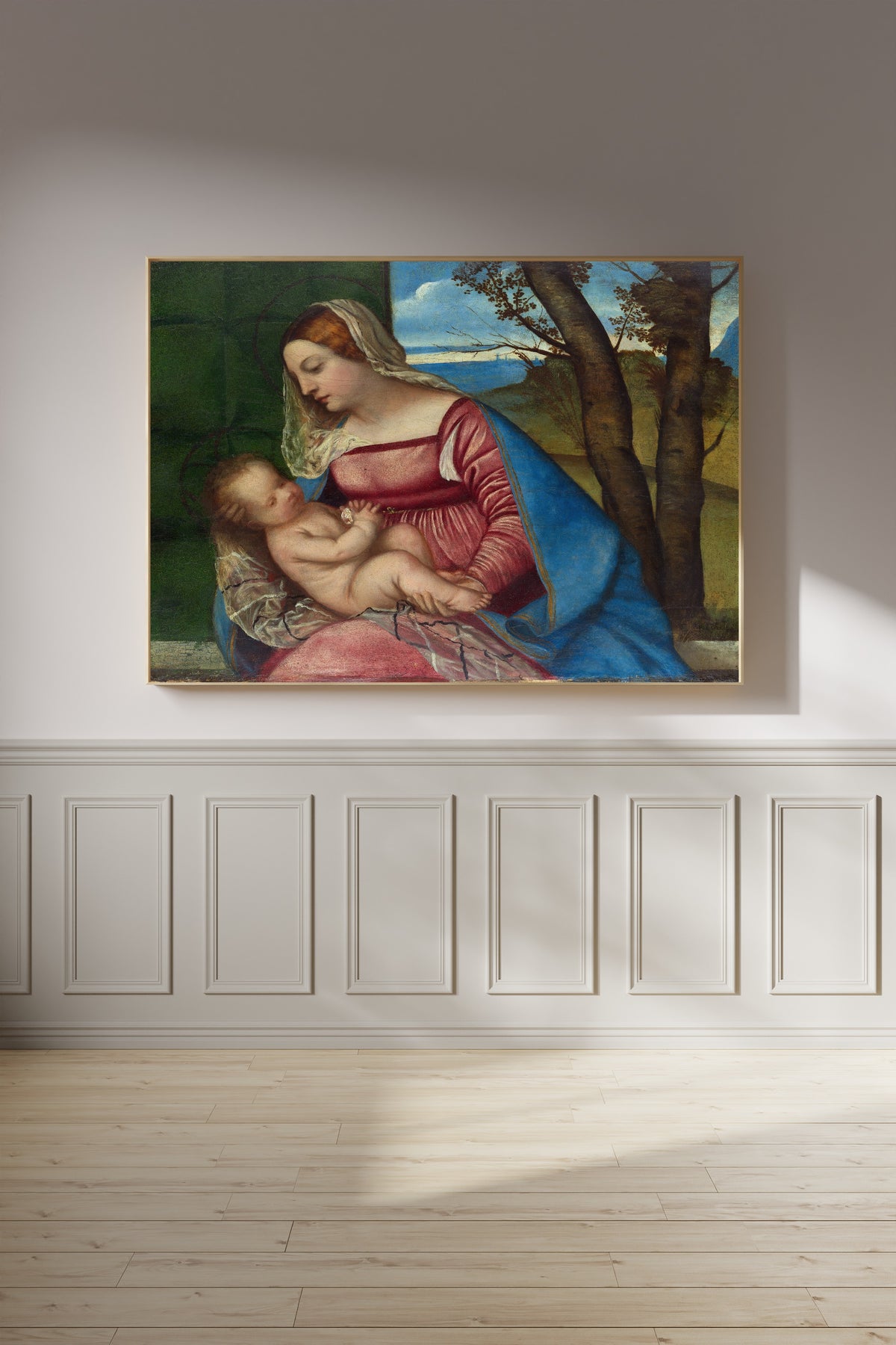 Framed art print of Madonna and Child by Titian, on a panelled wall in afternoon light