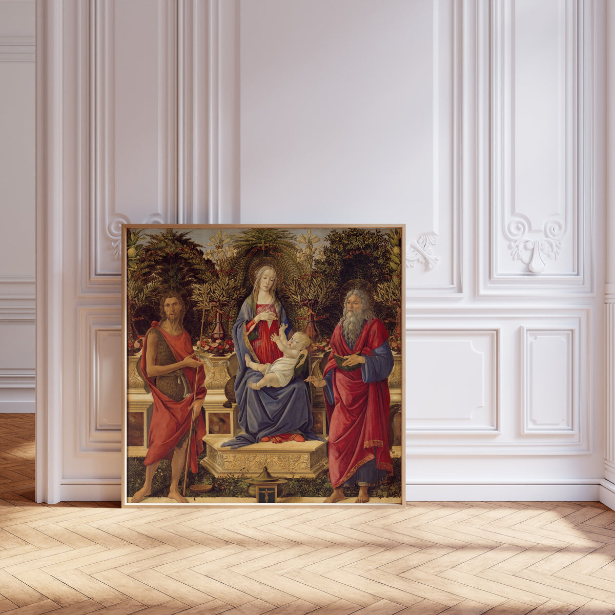 Framed art print of Madonna and Child with both Saints John by Sandro Botticelli, leaning against pale pink panelling on a herringbone floor
