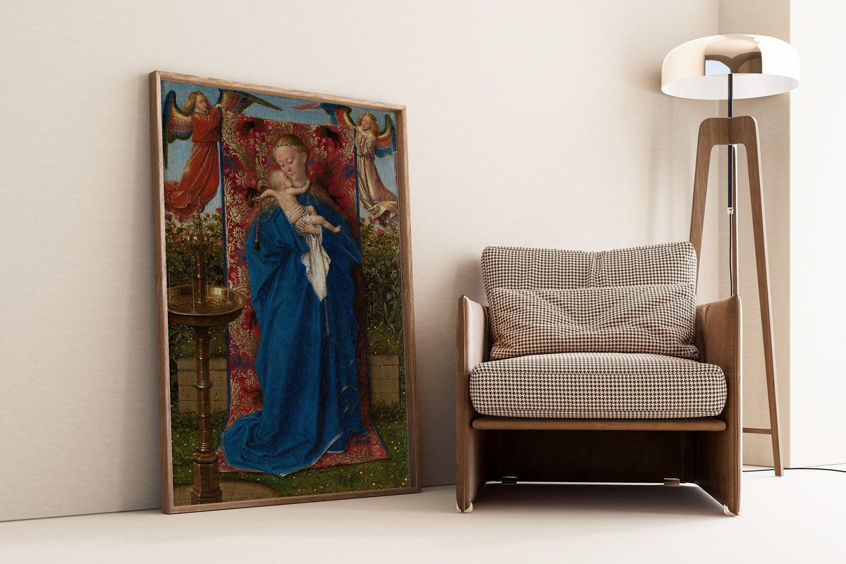 Framed art print of Madonna at the Fountain by Jan van Eyck, leaning against a wall beside an armchair and a floor lamp