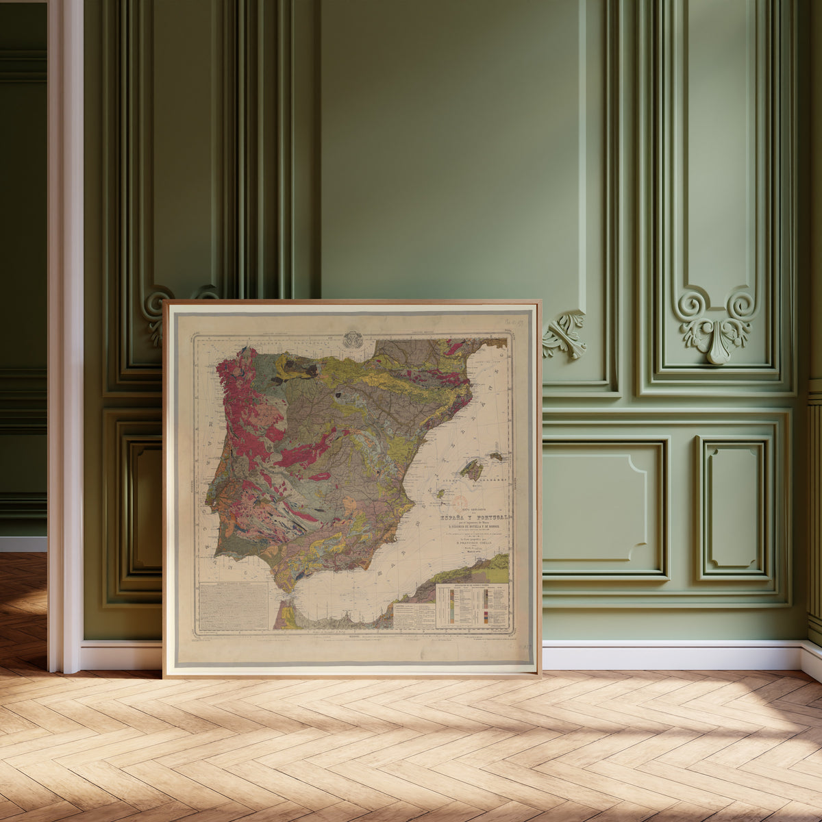 Mapa geológico de España y Portugal by Federico de Botella y de Hornos — framed and leaning against olive-green panelling on a herringbone floor