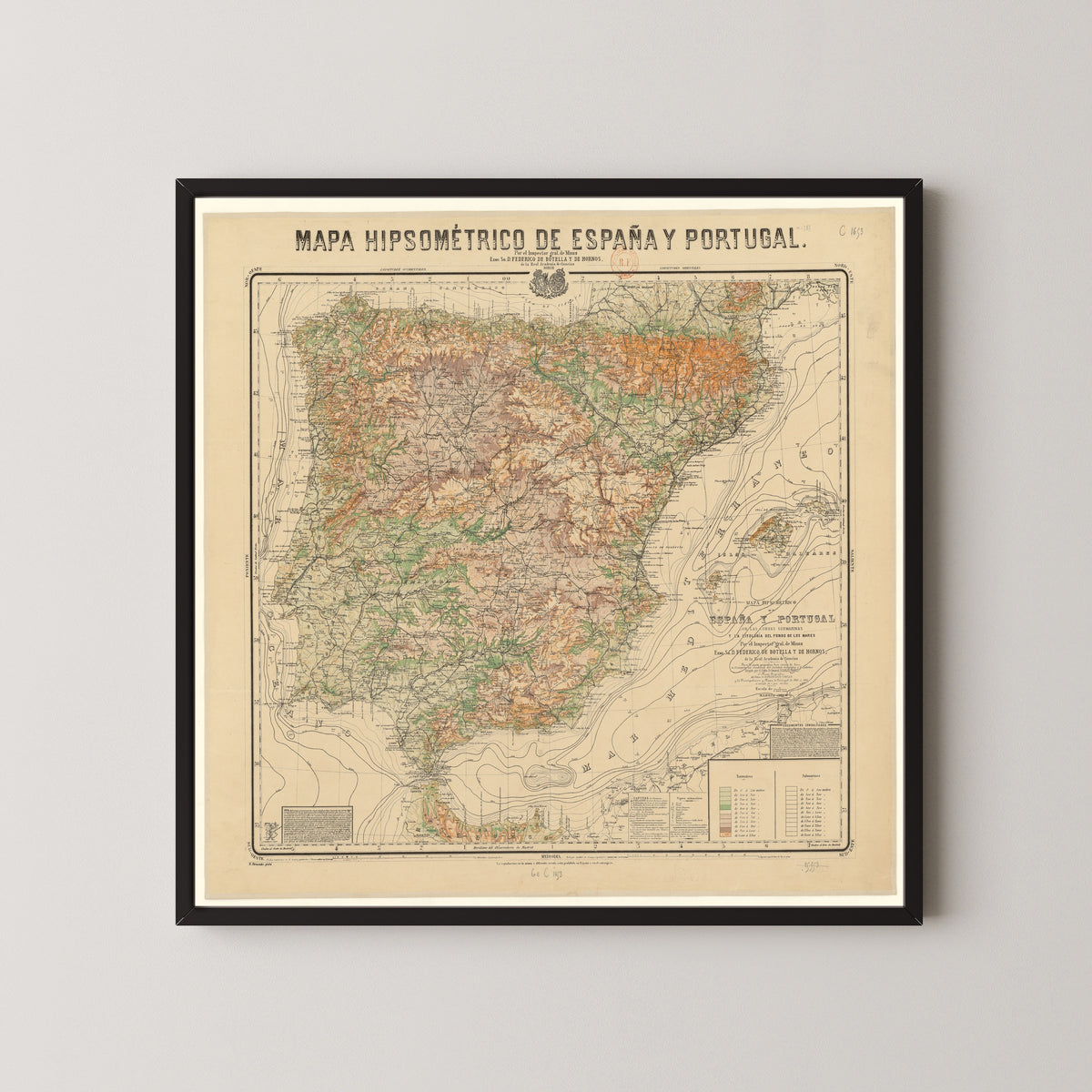 Mapa hipsométrico de España y Portugal by Federico de Botella y de Hornos — in a black frame on a pale wall