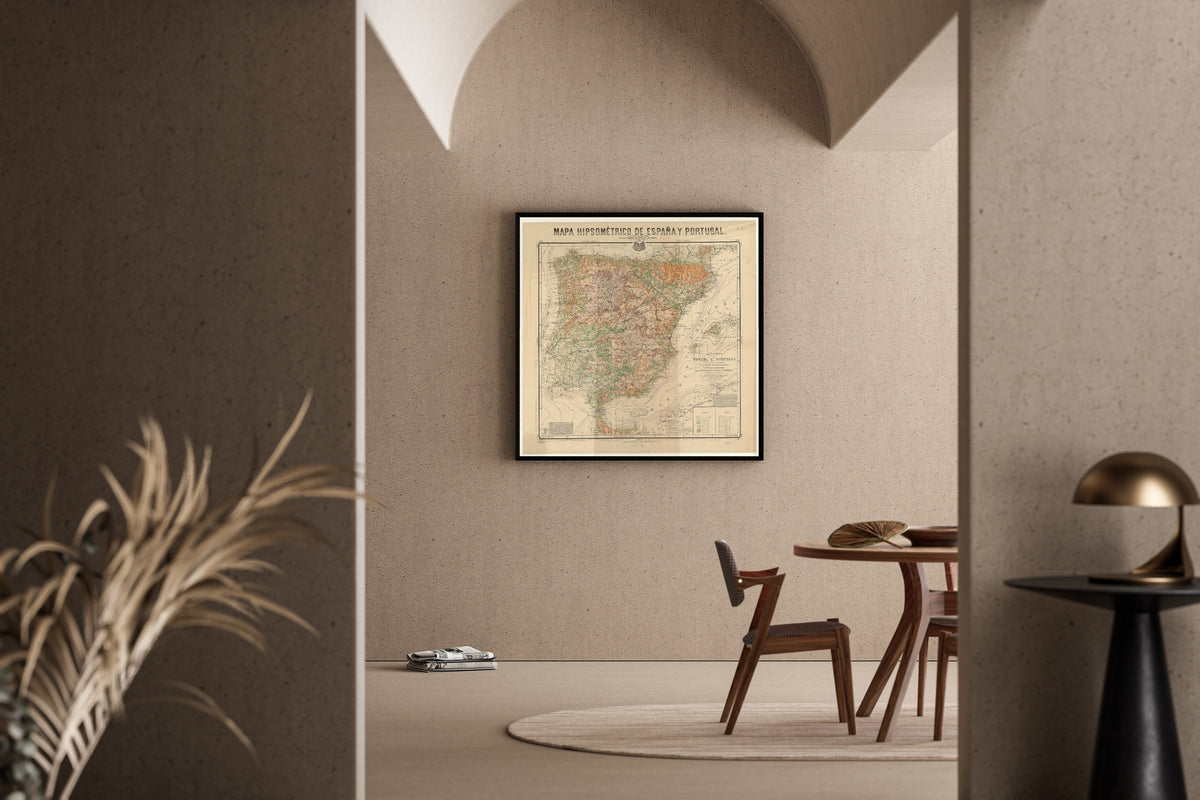 Mapa hipsométrico de España y Portugal by Federico de Botella y de Hornos — framed in a sunlit dining corner