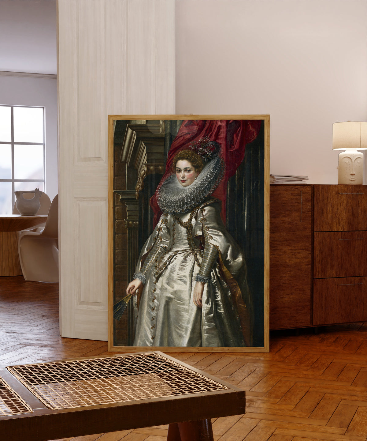 Framed art print of Marchesa Brigida Spinola Doria by Peter Paul Rubens, in a light wood frame leaning in a warm room with a parquet floor