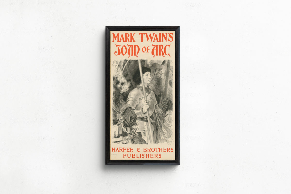 Framed art print of Mark Twain's Joan of Arc by Eugène Grasset, in a slim black frame on a plain white wall
