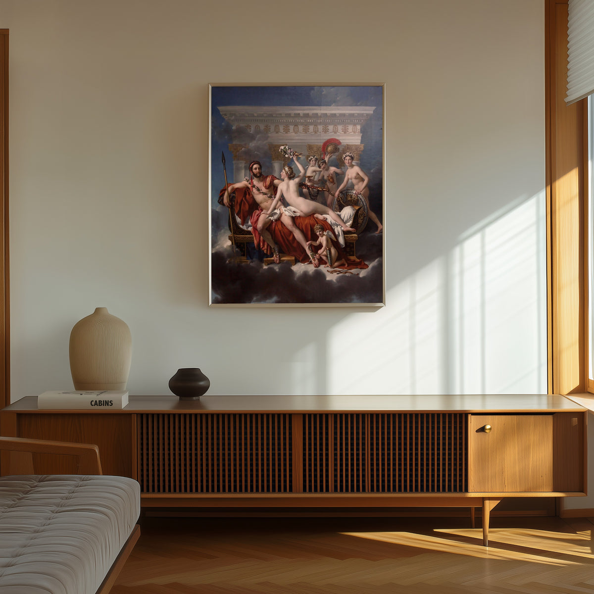 Framed art print of Mars Being Disarmed by Venus by Jacques-Louis David, in a thin light frame on a sunlit wall above a wooden sideboard