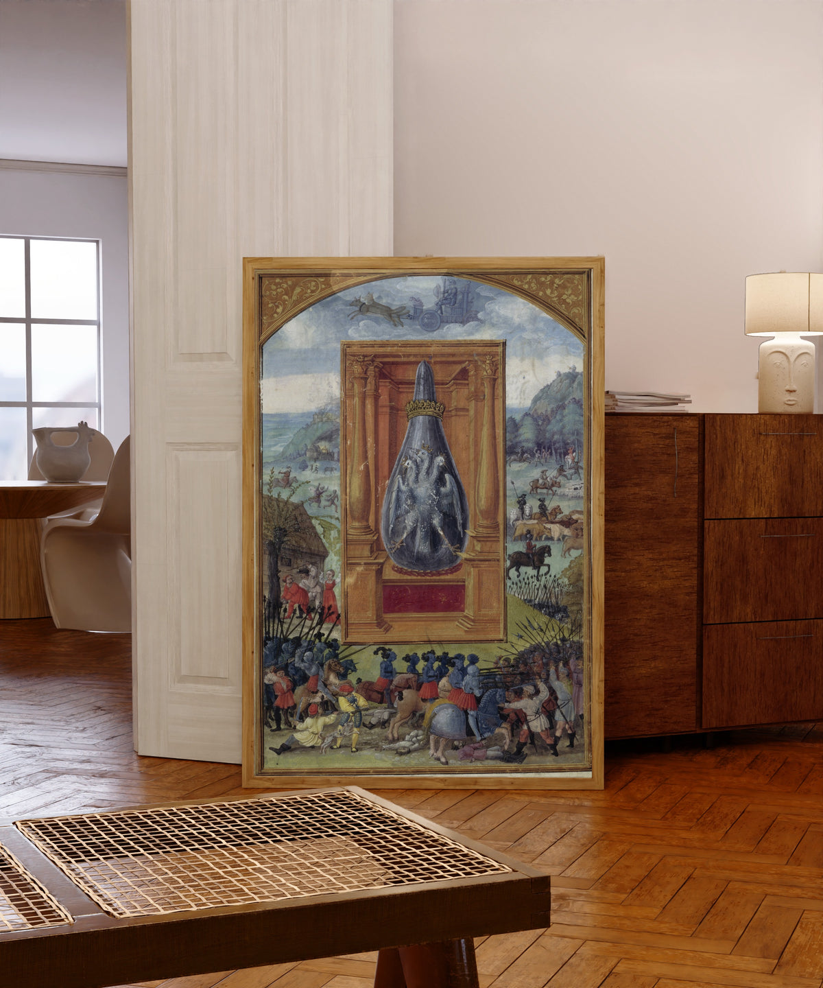 Framed art print of Mars and His Children by Splendor Solis, in a light wood frame leaning in a warm room with a parquet floor