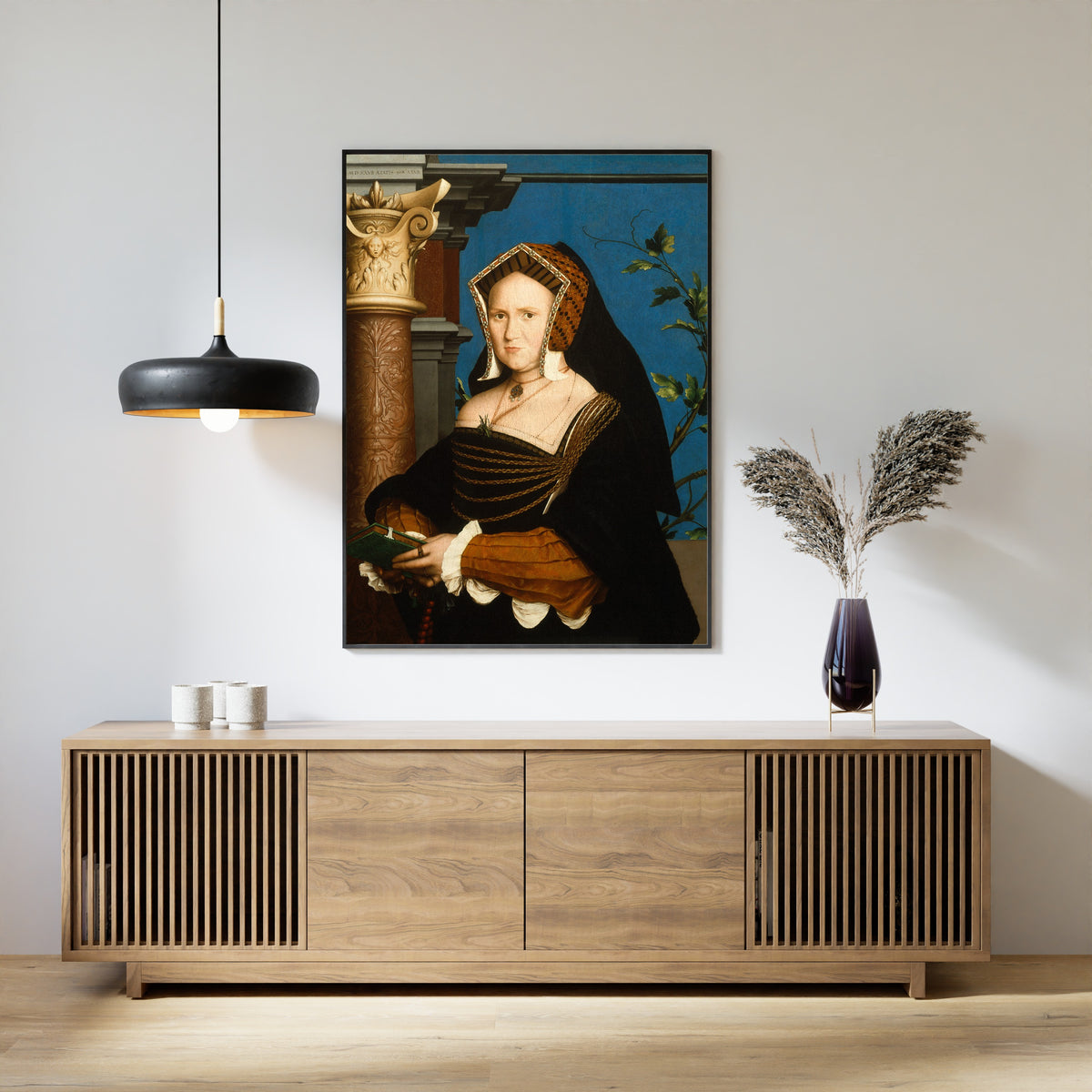 Framed art print of Mary, Lady Guildford by Hans Holbein the Younger, above a slatted wood sideboard