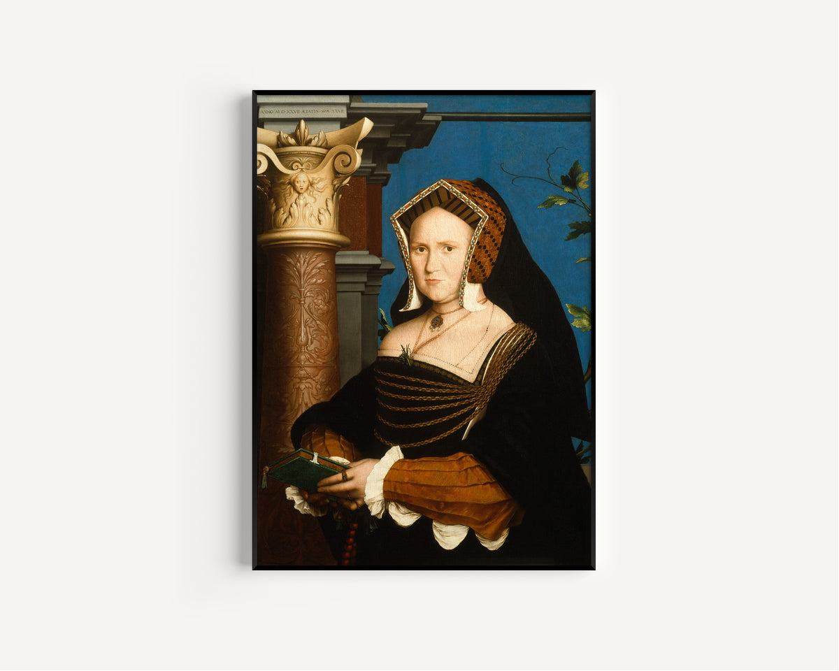 Framed art print of Mary, Lady Guildford by Hans Holbein the Younger, in a slim black frame on a plain white wall
