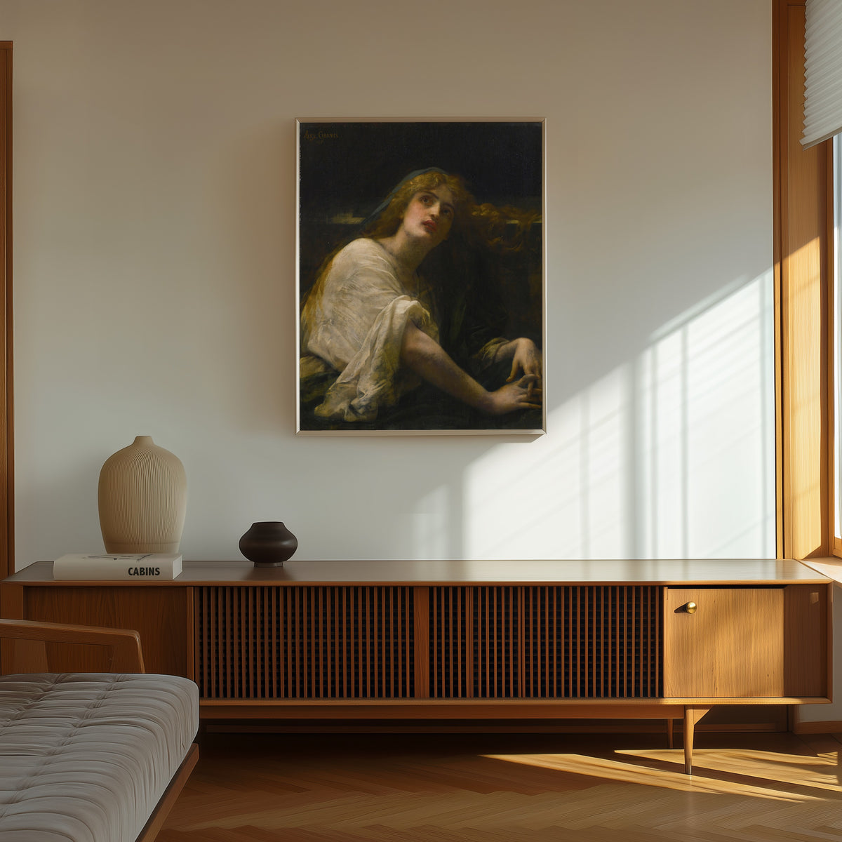 Framed art print of Mary Magdalene at the Tomb by Alexandre Cabanel, in a thin light frame on a sunlit wall above a wooden sideboard