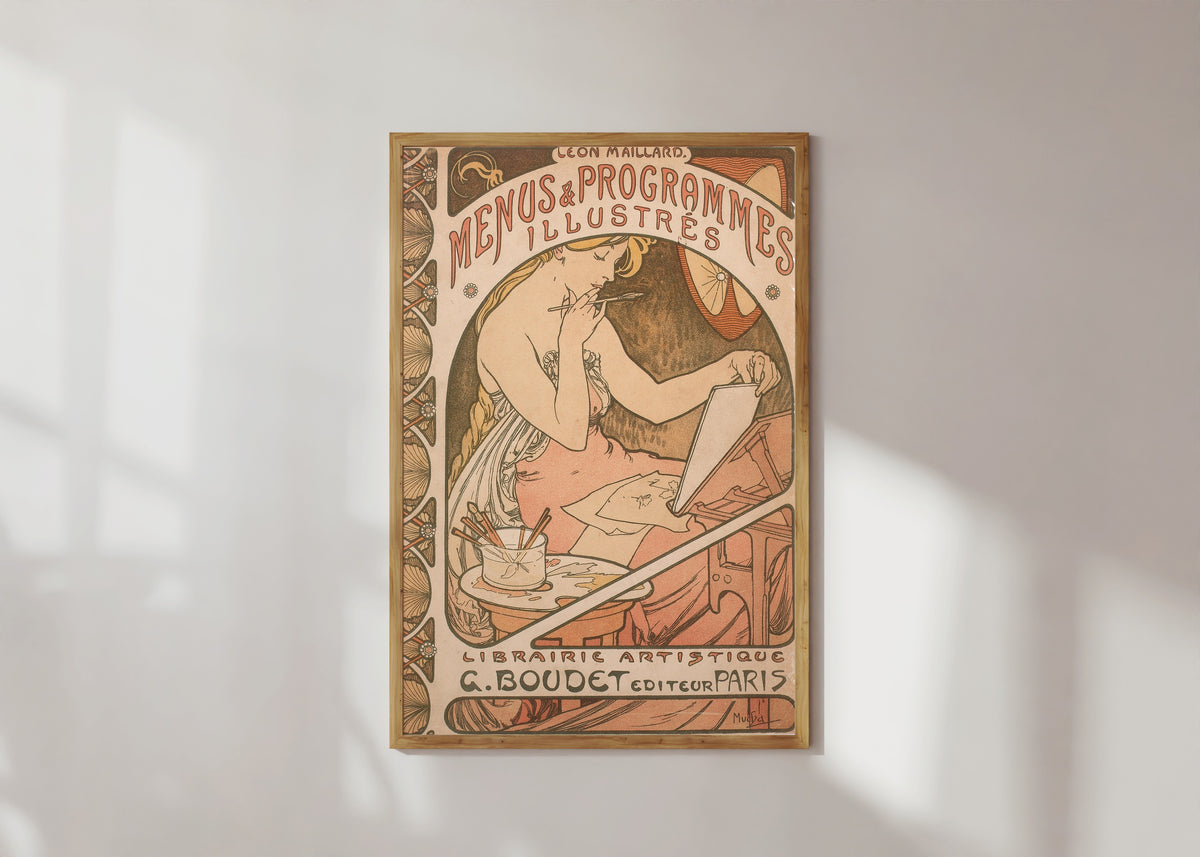 Framed art print of Menus et Programmes illustrés by Alphonse Mucha, in a light wood frame on a sunlit white wall